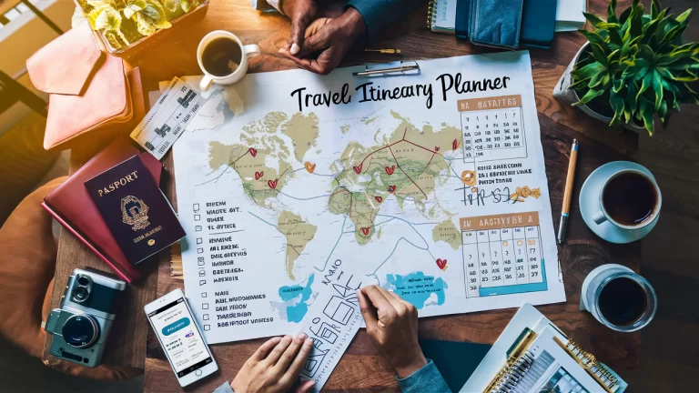 image of a detailed travel itinerary planner spread out on a wooden table. The planner should include a map with marked destinations, a calendar with dates and activities, and a checklist with items ticked off. Surrounding the planner, place travel-related items such as a passport, plane tickets, a camera, a smartphone displaying a travel app, and a coffee cup. The scene should be well-lit with natural light, giving it a warm and inviting feel. The overall aesthetic should be organized and visually appealing, reflecting the excitement and preparation involved in planning a trip.